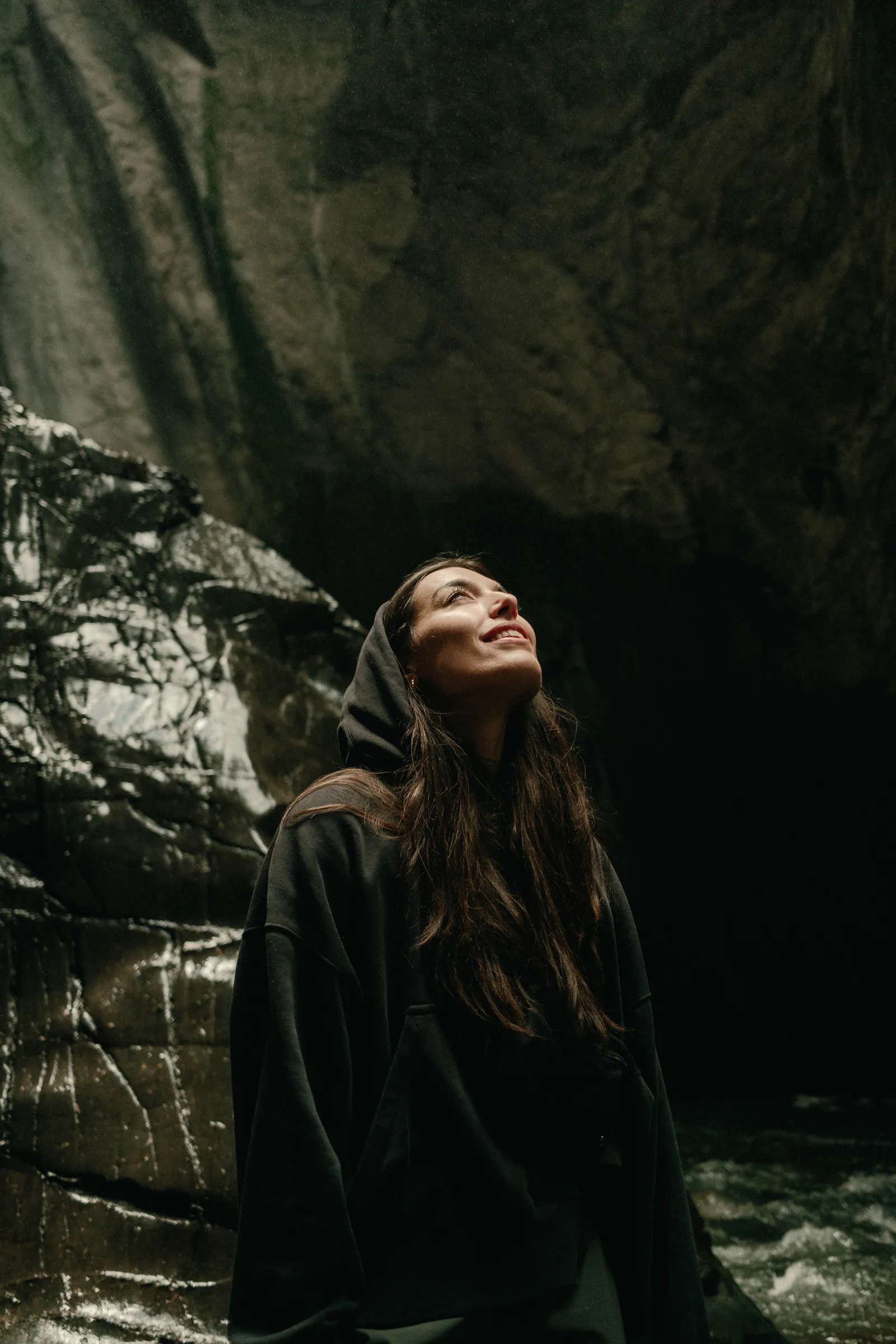 Julia Rodriguez looking up into the light in a canyon